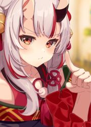 Rule 34 | 1girl, absurdres, bell, blurry, blurry background, blush, depth of field, double bun, frilled sleeves, frills, hair bell, hair bun, hair ornament, hand up, highres, hololive, horns, jingle bell, long hair, looking at viewer, multicolored hair, nakiri ayame, nakiri ayame (1st costume), oni, pom pom (clothes), red eyes, red hair, sidelocks, skin-covered horns, solo, streaked hair, tassel, tassel hair ornament, virtual youtuber, white hair, yomogi uehara