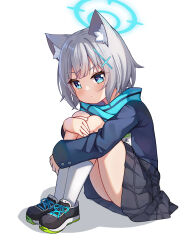 1girl absurdres animal_ear_fluff animal_ears black_skirt blue_archive blue_eyes blue_jacket blue_scarf expressionless full_body grey_hair halo highres hugging_own_legs jacket long_sleeves looking_at_viewer luxuriou_s plaid_clothes plaid_skirt scarf shiroko_(blue_archive) short_hair simple_background sitting skirt white_background wolf_ears wolf_girl