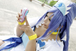 Rule 34 | 1girl, ankle boots, asian, blue eyes, blue hair, boots, bow, bracelet, breasts, cellphone, choker, chouzuki maryou, cleavage, cosplay, cure diamond, cure diamond (cosplay), dokidoki! precure, dress, headpiece, jewelry, large breasts, long hair, magical girl, matching hair/eyes, phone, photo (medium), plump, ponytail, precure, puffy short sleeves, puffy sleeves, ribbon, short sleeves, sitting, solo, tiara