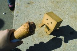 Rule 34 | black eyes, box, cardboard box, danboo, figure, food, highres, ice cream, ice cream cone, minimized, outstretched arms, photo (medium), source request, toy, triangle mouth, yotsubato!