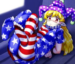 Rule 34 | 1girl, american flag dress, american flag legwear, blonde hair, blush, cloth gag, clownpiece, commentary request, commission, feet, frilled shirt collar, frills, furrowed brow, gag, gagged, hat, improvised gag, jester cap, long hair, lying, mono (moiky), neck ruff, no shoes, on back, over the nose gag, pantyhose, polka dot, red eyes, restrained, skeb commission, soles, solo, touhou