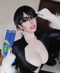 Rule 34 | 1girl, bayonetta, bayonetta (cosplay), bayonetta (series), black bra, black hair, blurry, blurry background, bra, breasts, cleavage, clothes, cosplay, female focus, glasses, gloves, holding, holding weapon, jyunaundomiel, large breasts, looking at viewer, photo (medium), real life, short hair, solo, underwear, weapon, white gloves