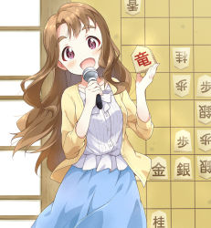 Rule 34 | 1girl, blouse, blue skirt, board game, brown hair, cardigan, commentary request, head tilt, holding, holding microphone, idolmaster, idolmaster million live!, long hair, long sleeves, looking at viewer, microphone, miyao miya, open cardigan, open clothes, open mouth, purple eyes, shirt, shogi, skirt, smile, solo, standing, toma (shinozaki), white shirt, yellow cardigan