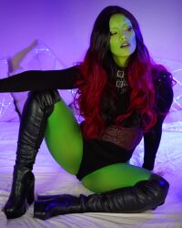 Rule 34 | 1girl, ass, black leotard, boots, breasts, colored skin, cosplay, full body, gamora, gamora (cosplay), green skin, highres, leotard, looking to the side, marvel, marvel cinematic universe, medium breasts, open mouth, photo (medium), red hair, simple background, sitting, skin tight, thighs, zoogirlq