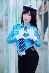 Rule 34 | 1girl, asian, brown hair, cosplay, d.va (overwatch), gloves, hat, heart, officer d.va, overwatch, overwatch 1, pants, photo (medium), police, police hat, police uniform, policewoman, rinnie riot, solo, uniform