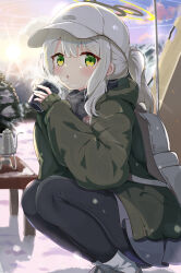 Rule 34 | 1girl, absurdres, backpack, bag, black pantyhose, blue archive, blush, boots, commentary, cup, green eyes, green jacket, grey footwear, grey hair, grey skirt, hair between eyes, halo, hare (blue archive), hare (camp) (blue archive), hat, highres, holding, holding cup, jacket, long hair, long sleeves, looking at viewer, mikumiku37, official alternate costume, outdoors, pantyhose, parted lips, ponytail, revision, skirt, solo, squatting, white hat