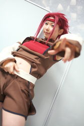 Rule 34 | 1girl, asian, blue eyes, blurry, chippi, code geass, color contacts, cosplay, depth of field, dutch angle, highres, indoors, kouzuki kallen, kouzuki kallen (cosplay), looking at viewer, midriff, photo (medium), pointing, pointing at viewer, red hair, short hair, solo
