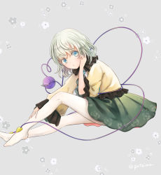 Rule 34 | 1girl, blue eyes, closed mouth, collared shirt, eyeball, floral background, floral print, frilled sleeves, frills, full body, green hair, green skirt, grey background, hand on own leg, happy, heart, heart of string, highres, komeiji koishi, looking at viewer, no headwear, no shoes, pantyhose, poteimo (poteimo622), shirt, short hair, simple background, sitting, skirt, smile, string, third eye, touhou, wavy hair, white pantyhose, wide sleeves, yellow shirt