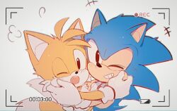 Rule 34 | 2boys, animal ears, animal nose, blue fur, blush, brown eyes, c52278, chinese commentary, closed mouth, commentary request, fox boy, fox ears, fox tail, furry, furry male, gloves, grey background, hands up, hedgehog, hedgehog ears, hedgehog tail, highres, hug, looking at viewer, male focus, multiple boys, multiple tails, one eye closed, open mouth, simple background, smile, sonic (series), sonic the hedgehog, sonic the hedgehog (classic), standing, tail, tails (sonic), teeth, tongue, two tails, viewfinder, white gloves, yellow fur