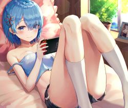 Rule 34 | 1girl, absurdres, bare shoulders, bed, black shorts, blue eyes, blue hair, blush, breasts, collarbone, commentary, crop top, day, feet out of frame, frilled pillow, frills, hair ornament, hair over one eye, handheld game console, highres, huge filesize, indoors, kneehighs, knees up, looking at viewer, lying, medium breasts, midriff, nintendo switch, on back, on bed, photo (object), pillow, plant, playing games, potted plant, re:zero kara hajimeru isekai seikatsu, rem (re:zero), ribbon, sarika, short hair, short shorts, shorts, smile, socks, solo, strap slip, thighs, white socks, window, x hair ornament