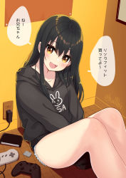 Rule 34 | 1girl, :d, between legs, black hair, black hoodie, black shorts, blush, brown eyes, controller, cutoffs, fang, feet out of frame, game controller, hair between eyes, hand between legs, hood, hood down, hoodie, knees up, long hair, long sleeves, looking at viewer, minamura haruki, on floor, open mouth, original, short shorts, shorts, sitting, sleeves past fingers, sleeves past wrists, smile, solo, translation request, twitter username