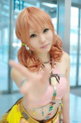 Rule 34 | 1girl, belt, bracelet, cosplay, female focus, final fantasy, final fantasy xiii, jewelry, looking at viewer, midriff, necklace, oerba dia vanille, oerba dia vanille (cosplay), pink shirt, shirt, skirt, solo, standing, twintails