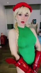 Rule 34 | 1girl, animated, ass, audible music, audible speech, bare shoulders, blonde hair, braid, breasts, cammy white, cammy white (cosplay), cosplay, female focus, fingerless gloves, gloves, green leotard, hat, indoors, interior, large breasts, leotard, long hair, looking at viewer, panamanian (nationality), photo (medium), real life, red gloves, smile, solo, sound, street fighter, tagme, teeth, thighs, video, windygirk