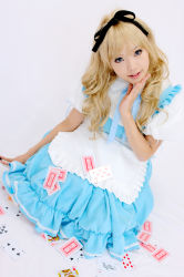 Rule 34 | 1girl, alice (alice in wonderland), alice (alice in wonderland) (cosplay), alice in wonderland, apron, asian, blonde hair, blue eyes, breasts, card, color contacts, cosplay, dutch angle, hair ribbon, indoors, kipi-san, long hair, looking at viewer, mole, petite, photo (medium), playing card, ribbon, simple background, small breasts, solo, white background