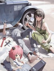 Rule 34 | 1boy, 2girls, absurdres, alternate costume, anya (spy x family), bare shoulders, barefoot, bingwei huang, blanket, breasts, car, child, commentary, english commentary, feet, green eyes, hairband, hairpods, highres, holding, holding wrench, large breasts, long hair, looking at viewer, lying, medium hair, motor vehicle, multiple girls, on back, overalls, pants, pink hair, repairing, shirt, shirt tucked in, short hair, short sleeves, smile, spy x family, toes, tools, twilight (spy x family), wheel, wrench, yor briar