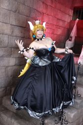 Rule 34 | 1girl, armlet, asian, bare shoulders, black collar, black dress, black nails, blonde hair, blue eyes, borrowed design, bowsette, bowsette (cosplay), bracelet, breasts, brooch, chouzuki maryou, cleavage, collar, cosplay, crown, dress, earrings, fingernails, highres, horns, jewelry, large breasts, lizard tail, long hair, looking at viewer, mario (series), nail polish, new super mario bros. u deluxe, nintendo, photo (medium), plump, shell, skirt, smile, solo, spiked armlet, spiked bracelet, spiked collar, spiked shell, spikes, standing, strapless, strapless dress, super crown, tail, turtle shell