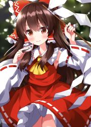 Rule 34 | 1girl, ascot, bare shoulders, blush, bow, brown eyes, brown hair, closed mouth, cowboy shot, detached sleeves, frilled skirt, frills, gohei, hair between eyes, hair bow, hair tubes, hakurei reimu, highres, holding, japanese clothes, long hair, nontraditional miko, ofuda, red bow, red skirt, ribbon-trimmed sleeves, ribbon trim, ruu (tksymkw), sidelocks, skirt, smile, solo, touhou, wide sleeves, yellow ascot