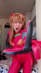 Rule 34 | 1girl, angry, animated, ass, bodysuit, brazilian (nationality), cat, cosplay, female focus, green eyes, index finger raised, indoors, long hair, looking at viewer, lowres, meme, neon genesis evangelion, nerokosplayer, open mouth, orange hair, photo (medium), plugsuit, pointing, pointing at viewer, real life, red bodysuit, solo, sound, souryuu asuka langley, tsundere, video