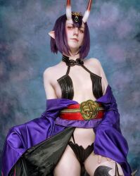 Rule 34 | 1girl, breasts, cosplay, fate/grand order, fate (series), female focus, highres, horns, moon usagi, photo (medium), pointy ears, purple eyes, purple hair, russian (nationality), short hair, shuten douji (fate), skin-covered horns, small breasts, solo, standing