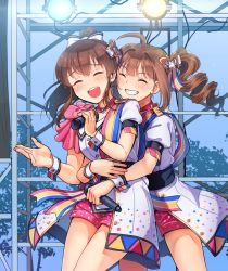 Rule 34 | 2girls, ^ ^, ahoge, blush, bow, breasts, closed eyes, collarbone, cowboy shot, day, drill hair, facing away, grin, hair bow, holding, holding microphone, hug, hug from behind, idolmaster, idolmaster million live!, idolmaster million live! theater days, kamille (vcx68), large breasts, microphone, multiple girls, nouvelle tricolore (idolmaster), open mouth, outdoors, parted lips, puffy short sleeves, puffy sleeves, satake minako, short hair, short ponytail, short sleeves, side drill, smile, stage lights, teeth, white bow, wrist cuffs, yokoyama nao