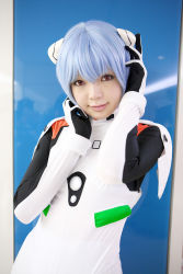 Rule 34 | 1girl, asian, ayanami rei, blue hair, color contacts, cosplay, hairpods, highres, looking at viewer, namada, neon genesis evangelion, photo (medium), plugsuit, red eyes, short hair, solo, standing