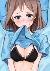 Rule 34 | 10s, 1girl, black bra, blue eyes, blush, bra, breasts, cleavage, clothes in mouth, clothes lift, grey hair, highres, looking at viewer, love live!, love live! sunshine!!, lying, medium breasts, medium hair, mouth hold, on back, pillow, shirt in mouth, shirt lift, solo, sweat, syoamami, underwear, upper body, watanabe you