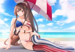 1girl, alternate costume, american flag bikini, american flag legwear, beach, beach umbrella, bikini, blush, breasts, brown eyes, brown hair, cleavage, cloud, collarbone, commentary request, day, flag print, hair ornament, highres, holding, holding umbrella, kantai collection, large breasts, long hair, looking at viewer, navel, ocean, outdoors, ponytail, print swimsuit, red umbrella, single thighhigh, sitting, sky, solo, star (symbol), star hair ornament, striped, swimsuit, thighhighs, umbrella, very long hair, yamato (kancolle), yokozuwari, yunamaro