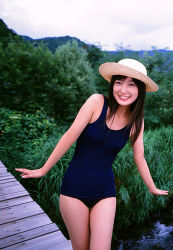 Rule 34 | 1girl, black hair, blue one-piece swimsuit, breasts, brown hair, cloud, cowboy shot, day, grin, happy, hat, hill, leaning to the side, legs together, lips, lipstick, long hair, looking at viewer, lowres, makeup, medium breasts, nature, new school swimsuit, one-piece swimsuit, outdoors, photo (medium), pier, real life, red lips, school swimsuit, smile, solo, standing, sun hat, swimsuit, thigh gap