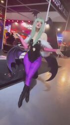 Rule 34 | 1girl, animated, argentine (nationality), audible music, bare shoulders, bat wings, black leotard, breasts, cleavage, cosplay, crossed legs, curvy, demon girl, fingernails, green hair, head wings, highleg, highleg leotard, highres, legs together, leotard, medium breasts, morrigan aensland, morrigan aensland (cosplay), pale skin, pantyhose, parted lips, photo (medium), real life, smile, solo, sophie valentine, sound, tagme, thick thighs, thighs, vampire (game), video, wide hips, wings