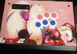 Rule 34 | 1girl, arcade, arcade stick, ass, bent over, blonde hair, cammy white, controller, game controller, hat, joystick, photo (medium), solo, street fighter, top-down bottom-up, zonda (solid air)