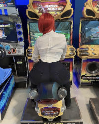 Rule 34 | 1girl, arcade, ass, black pants, chainsaw man, cosplay, dulce chan, highres, huge ass, long hair, makima (chainsaw man), makima (chainsaw man) (cosplay), pants, pantylines, photo (medium), real life, red hair, shirt, solo, white shirt, wide hips