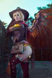 Rule 34 | 1girl, angel, blonde hair, blondiee, book, cosplay, halloween, hat, looking at viewer, mercy (overwatch), overwatch, overwatch 1, photo (medium), short hair, solo, wings, witch, witch mercy