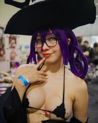 Rule 34 | 1girl, bikini, black bikini, blair (soul eater), blair (soul eater) (cosplay), breasts, cosplay, female focus, glasses, hat, large breasts, looking at viewer, mexican (nationality), micro bikini, mole, mole on breast, oz cosplay, photo (medium), purple hair, smile, solo, soul eater, swimsuit, witch hat, yellow eyes