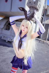 Rule 34 | 1girl, arty huang (cosplayer), blonde hair, brown eyes, chinese text, cosplay photo, elbow gloves, feet out of frame, from above, gloves, hair between eyes, hairband, highres, kantai collection, long hair, looking at viewer, midriff, mismatched eyebrows, navel, outdoors, photo (medium), pink lips, rensouhou-chan, school uniform, second-party source, serafuku, shimakaze (kancolle), ship, solo, striped clothes, striped thighhighs, thighhighs, very long hair, watercraft, watermark, white gloves