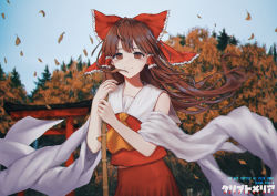 Rule 34 | 1girl, artist request, autumn leaves, bamboo broom, bare shoulders, blush, bow, broom, brown eyes, brown hair, day, detached sleeves, floating hair, hair tubes, hakurei reimu, highres, leaf, long hair, maple leaf, motion blur, outdoors, red bow, sky, smile, solo, touhou, upper body, wide sleeves