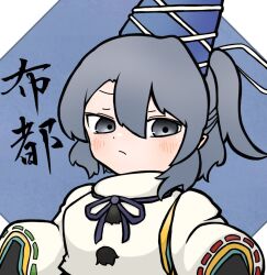 Rule 34 | 1girl, blue background, blue hat, blush, closed mouth, commentary, grey eyes, hair between eyes, hari oekaki, hat, japanese clothes, kariginu, long sleeves, looking at viewer, mononobe no futo, pom pom (clothes), ponytail, ribbon-trimmed sleeves, ribbon trim, short hair, solo, tate eboshi, touhou, wide sleeves