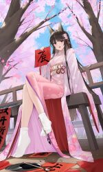 1girl akagi_(warship_girls_r) animal_ears black_hair calligraphy_brush cherry_blossoms chichengde_haotidu_afusang floral_print flower fox_ears full_body hair_flower hair_ornament highres holding japanese_clothes kimono long_hair looking_at_viewer obi open_mouth paintbrush pink_kimono sash sitting socks solo tabi tree very_long_hair warship_girls_r white_socks wide_sleeves