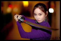 Rule 34 | 1girl, alodia gosiengfiao, asian, blurry, cosplay, cosplay request, depth of field, earrings, facing viewer, fighting stance, jewelry, katana, long hair, looking at viewer, lowres, ponytail, purple sweater, solo, sweater, sword, weapon