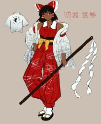 Rule 34 | 1girl, absurdres, alternate skin color, bare shoulders, black hair, bow, closed mouth, commentary, dark-skinned female, dark skin, english commentary, full body, gohei, grey background, hair bow, hair tubes, hakurei reimu, highres, holding, holding gohei, jacket, japanese clothes, looking at viewer, medium hair, off-shoulder jacket, off shoulder, pants, red bow, red eyes, red pants, red shirt, ribbon, sandals, shirt, simple background, sleeveless, sleeveless shirt, socks, solo, touhou, white jacket, white socks, wingupingu (shikishikichan), yellow bow, yellow ribbon