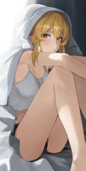 Rule 34 | 1girl, absurdres, alternate costume, arms on knees, bare arms, bare legs, black shorts, blonde hair, blush, breasts, cleavage, closed mouth, crop top, genshin impact, hair between eyes, highres, knees up, large breasts, looking at viewer, lumine (genshin impact), midriff, short hair with long locks, short shorts, shorts, sitting, so shio, solo, tank top, thighs, under covers, white tank top, yellow eyes