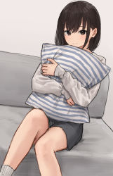 Rule 34 | 1girl, akipeko, bad id, bad twitter id, blush, brown eyes, brown hair, closed mouth, couch, grey shorts, hands up, highres, hugging object, indoors, long sleeves, looking at viewer, making-of available, original, pillow, pillow hug, shirt, short hair, shorts, sitting, smile, socks, solo, white shirt, white socks