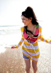 Rule 34 | 1girl, beach, black hair, breasts, brown eyes, chihara minori, colorful, jewelry, long hair, necklace, ocean, outdoors, photo (medium), sand, voice actor, shorts, smile, striped, teeth, water