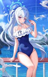 Rule 34 | 1girl, absurdres, animal, bare arms, bare legs, bare shoulders, bird, blue archive, blue halo, blue one-piece swimsuit, blush, cellphone, closed mouth, day, feet out of frame, frilled one-piece swimsuit, frills, grey hair, halo, highres, holding, holding phone, kesa pasa, long hair, looking at viewer, miyako (blue archive), miyako (swimsuit) (blue archive), ocean, off-shoulder one-piece swimsuit, off shoulder, official alternate costume, one-piece swimsuit, outdoors, phone, ponytail, purple eyes, seagull, smartphone, smile, solo, swimsuit