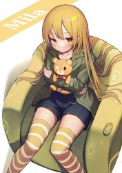 Rule 34 | 1girl, absurdres, blonde hair, blue shorts, brown eyes, character name, feet out of frame, green jacket, hair flowing over, highres, holding, holding stuffed toy, hugging doll, hugging object, jacket, long hair, looking at viewer, mamemochi, original, shorts, sitting, solo, striped clothes, striped thighhighs, stuffed animal, stuffed toy, teddy bear, thighhighs, very long hair