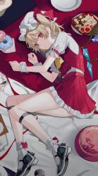 Rule 34 | 1girl, absurdres, ascot, black footwear, blonde hair, bobby socks, bow, cake, checkerboard cookie, chocolate, cookie, crystal, curled up, daimaou ruaeru, doughnut, flandre scarlet, food, frilled skirt, frilled sleeves, frills, fruit, full body, hat, hat bow, highres, looking at viewer, lying, mary janes, medium hair, mob cap, on side, one side up, parted lips, plate, red bow, red eyes, red skirt, red vest, shirt, shoes, short sleeves, skirt, socks, solo, strawberry, tablecloth, touhou, vest, white hat, white shirt, white socks, wings, wrist cuffs, yellow ascot