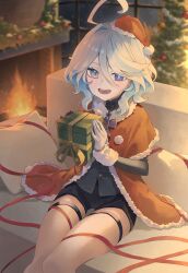 Rule 34 | 1girl, black shorts, blue eyes, capelet, christmas, christmas ornaments, christmas present, christmas tree, commentary, cowlick, elmo (st elmomomo), fire, fur-trimmed capelet, fur trim, furina (genshin impact), genshin impact, gift, gloves, hat, highres, holding, holding gift, indoors, looking at viewer, open mouth, red capelet, red hat, santa hat, short hair, shorts, sitting, smile, solo, upper body, white gloves, white hair