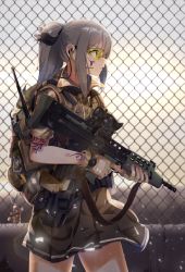 Rule 34 | 1girl, assault rifle, backpack, bag, bag charm, black skirt, brown gloves, bullpup, carbine, casino (casinoep), chain-link fence, charm (object), closed mouth, cowboy shot, fence, fingerless gloves, from behind, gloves, goggles, grey hair, gun, headset, highres, holding, holding gun, holding weapon, l85, lens flare, load bearing vest, long hair, machine gun, military, original, outdoors, pleated skirt, ponytail, profile, rifle, sa80, scope, short sleeves, sidelocks, skirt, solo, squad automatic weapon, tattoo, trigger discipline, weapon, yellow eyes