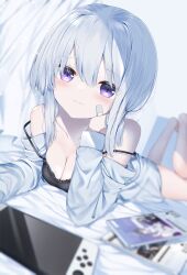 Rule 34 | 1girl, absurdres, bandaid, bandaid on cheek, bandaid on face, barefoot, black camisole, blurry, blurry foreground, blush, breasts, camisole, cleavage, closed mouth, curtains, depth of field, grey hair, hair between eyes, handheld game console, highres, legs up, long sleeves, looking at viewer, lying, medium breasts, neku (neku draw), off shoulder, on stomach, open clothes, open shirt, original, puffy long sleeves, puffy sleeves, purple eyes, shirt, smile, solo, white shirt