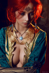 Rule 34 | 1girl, blue eyes, blurry, braid, breasts, center opening, circlet, cleavage, cosplay, costume, depth of field, dress, eyeliner, eyeshadow, freckles, green eyes, helly von valentine (disharmonica), highres, indoors, jewelry, large breasts, long hair, looking down, makeup, medium breasts, necklace, no bra, pendant, photo (medium), red hair, robe, side braids, solo, the witcher (series), triss merigold, triss merigold (cosplay)