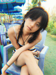 Rule 34 | 1girl, asian, bikini, black hair, breasts, chair, female focus, jewelry, legs, looking at viewer, necklace, photo (medium), sitting, small breasts, solo, striped bikini, striped clothes, swimsuit
